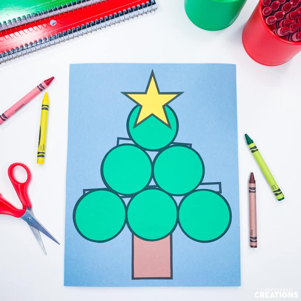 Yellow star shown glued on Christmas Tree Shape Craft template.